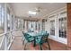 Relaxing screened porch with a glass table, seating, ceiling fan, and natural light at 5309 Shoreline Ct, Holly Springs, NC 27540