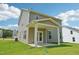 Home backyard featuring a covered patio and well-maintained lawn at 542 Winding Crk Dr, Lillington, NC 27546