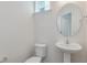 Stylish half bath featuring a pedestal sink and modern fixtures at 542 Winding Crk Dr, Lillington, NC 27546