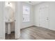 Bright half bath with a pedestal sink and wood-look flooring at 542 Winding Crk Dr, Lillington, NC 27546