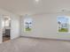 Bedroom with bright windows and an open doorway to a modern bathroom at 542 Winding Crk Dr, Lillington, NC 27546