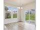 Sun-filled dining area with backyard views through a sliding glass door and large windows at 542 Winding Crk Dr, Lillington, NC 27546
