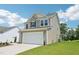 Two-story home featuring a two-car garage and well-maintained lawn at 542 Winding Crk Dr, Lillington, NC 27546