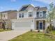 Beautiful two-story home with white siding, stone accents, and a two-car garage at 542 Winding Crk Dr, Lillington, NC 27546