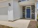 Stylish entryway showcases a blue front door with stone accents and a two-car garage at 542 Winding Crk Dr, Lillington, NC 27546