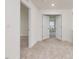 Bright hallway with neutral carpet and white doors leading to other rooms at 542 Winding Crk Dr, Lillington, NC 27546