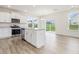 Bright, open kitchen with stainless steel appliances and a large island at 542 Winding Crk Dr, Lillington, NC 27546