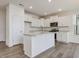 Modern kitchen with white cabinets, stainless steel appliances, and a center island at 542 Winding Crk Dr, Lillington, NC 27546