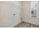 Functional laundry room with a wire shelf, hookups, a small window, and modern flooring at 542 Winding Crk Dr, Lillington, NC 27546