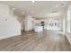 Open-concept home with hardwood floors, lots of light, and views into the kitchen and dining areas at 542 Winding Crk Dr, Lillington, NC 27546