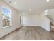 A light-filled living room boasts hardwood floors, large windows, and access to the upper floors at 542 Winding Crk Dr, Lillington, NC 27546