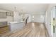 Open-concept layout featuring a kitchen island flowing into a spacious living area with stairs at 542 Winding Crk Dr, Lillington, NC 27546
