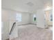 Upstairs loft area features carpet, bright light from the windows, and access to the bedrooms at 542 Winding Crk Dr, Lillington, NC 27546