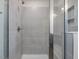 Tiled walk-in shower featuring a glass door and a built-in bench at 542 Winding Crk Dr, Lillington, NC 27546
