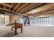 Unfinished basement with exposed beams and duct work with a foosball table and a water tank at 612 Jasmine St, Wendell, NC 27591