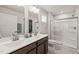 Well-lit bathroom features a double vanity and glass-enclosed shower for convenience at 612 Jasmine St, Wendell, NC 27591