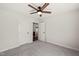 Neutral bedroom with a ceiling fan and two doors that lead to a closet and a bathroom at 612 Jasmine St, Wendell, NC 27591