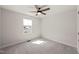Neutral bedroom with a window that provides natural light and a ceiling fan at 612 Jasmine St, Wendell, NC 27591