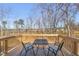 Cozy outdoor deck featuring a table and chairs for relaxing in a natural setting at 612 Jasmine St, Wendell, NC 27591