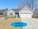 Charming single-story home boasts a two-car garage and a welcoming blue front door at 612 Jasmine St, Wendell, NC 27591