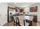 Modern kitchen with stainless steel appliances, island with seating, and granite countertops at 612 Jasmine St, Wendell, NC 27591