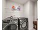 Efficient laundry room with front load washer and dryer, plus shelf for storage of supplies at 612 Jasmine St, Wendell, NC 27591