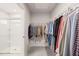 Spacious walk-in closet with hanging racks and a shower room for convenience and organization at 612 Jasmine St, Wendell, NC 27591