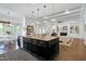 Open concept kitchen with large island overlooking a living space with fireplace and breakfast nook at 809 Rockhouse Ct, Cary, NC 27519