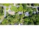 Overhead view of a residence with a large, well-maintained yard and mature trees in a peaceful neighborhood at 826 Warwick Ct, Burlington, NC 27215