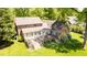 A beautiful brick home with a wooden deck, perfect for outdoor entertaining and relaxing in the landscaped backyard at 826 Warwick Ct, Burlington, NC 27215