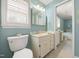 Bright bathroom with a soaking tub, tile floors, double sink vanity, and updated fixtures at 826 Warwick Ct, Burlington, NC 27215