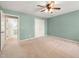 This bedroom features light green walls, a ceiling fan, and a double-door closet at 826 Warwick Ct, Burlington, NC 27215
