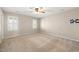 Large bedroom with carpet, a ceiling fan, and windows providing ample natural light at 826 Warwick Ct, Burlington, NC 27215