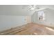 Cozy bedroom featuring hardwood floors, a ceiling fan, and a window offering natural light at 826 Warwick Ct, Burlington, NC 27215