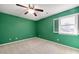 Bright bedroom with a large window, green walls, and neutral carpeting at 826 Warwick Ct, Burlington, NC 27215