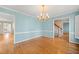 Dining room with hardwood floors, light blue walls, and a staircase in the background at 826 Warwick Ct, Burlington, NC 27215