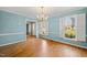 Dining room with hardwood floors, light blue walls, and natural light, creating a cozy atmosphere at 826 Warwick Ct, Burlington, NC 27215