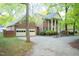 A beautiful two-story brick home with white columns, a two-car garage, and a spacious driveway at 826 Warwick Ct, Burlington, NC 27215