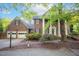 Charming two-story brick home with white columns, a two-car garage, and lush landscaping at 826 Warwick Ct, Burlington, NC 27215