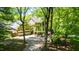 An aerial view of a two-story brick home with mature landscaping and a long driveway at 826 Warwick Ct, Burlington, NC 27215