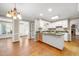 Well-lit kitchen boasting a granite-topped island, stainless steel appliances, and hardwood flooring at 826 Warwick Ct, Burlington, NC 27215