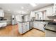 Contemporary kitchen featuring stainless steel appliances, a large island, and ample cabinet space at 826 Warwick Ct, Burlington, NC 27215