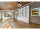 Versatile room with brick walls, white storage, and large windows offering natural light, creating a serene space at 826 Warwick Ct, Burlington, NC 27215