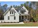 Charming two-story white home featuring board and batten siding, gabled roof, and a welcoming front porch at 842 Magnolia Acres Ln, Fuquay Varina, NC 27526