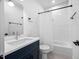 Clean bathroom with navy vanity, white subway tile shower, and modern fixtures at 857 Athens Dr # 102, Raleigh, NC 27606