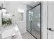 Well-lit bathroom featuring a double sink vanity and sleek, glass-enclosed shower at 857 Athens Dr # 102, Raleigh, NC 27606