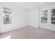 Bright, empty bedroom featuring neutral carpet and multiple windows for natural light at 857 Athens Dr # 102, Raleigh, NC 27606