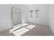 Minimalist bedroom with large mirror, neutral carpet, and bright windows at 857 Athens Dr # 102, Raleigh, NC 27606