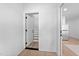 Bright entryway featuring hardwood floors and an open doorway to the stairs at 857 Athens Dr # 102, Raleigh, NC 27606