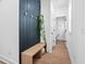 Bright entryway with hardwood floors, bench, and dark accent wall at 857 Athens Dr # 102, Raleigh, NC 27606